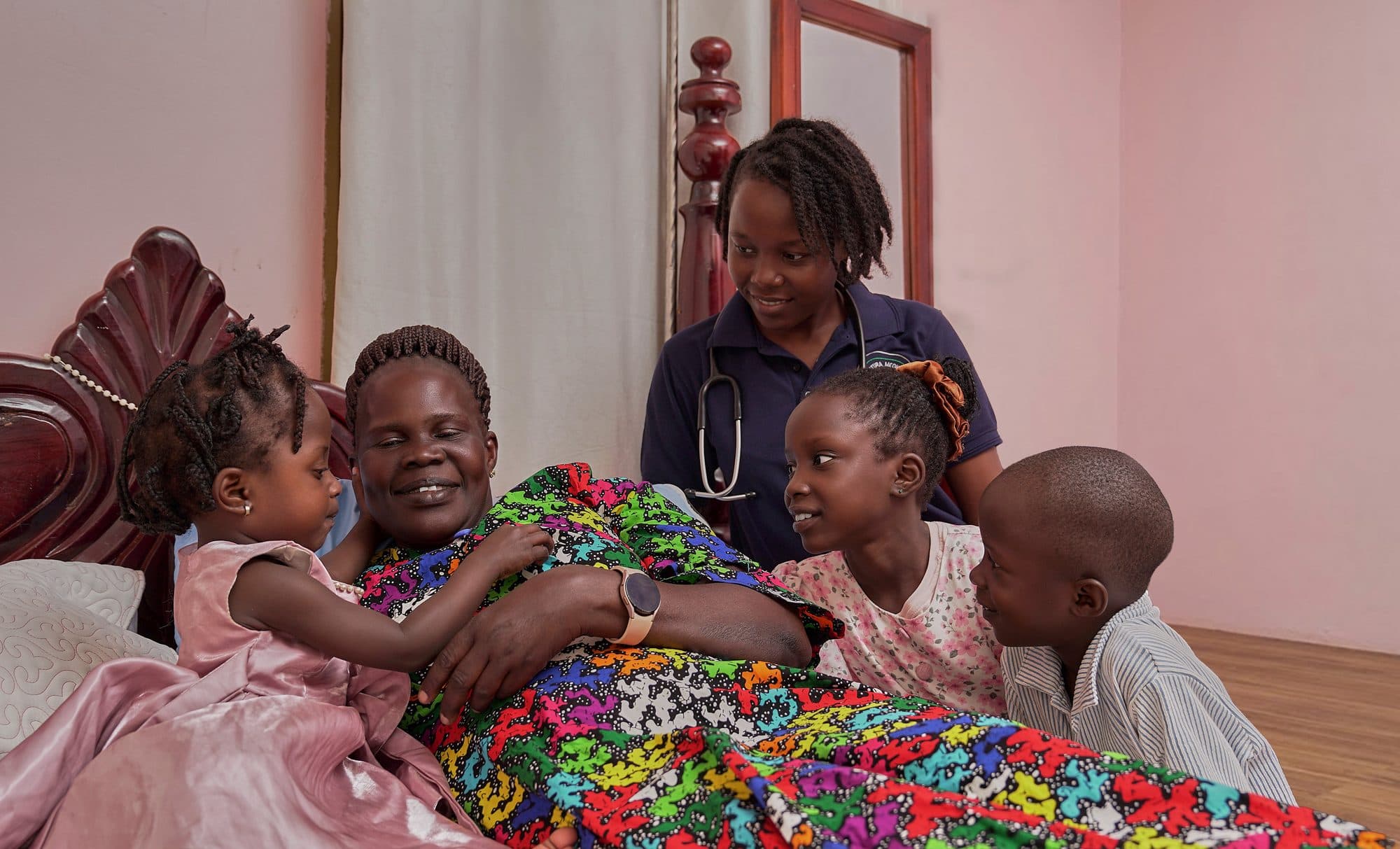 A caregiver visiting an elderly patient at home