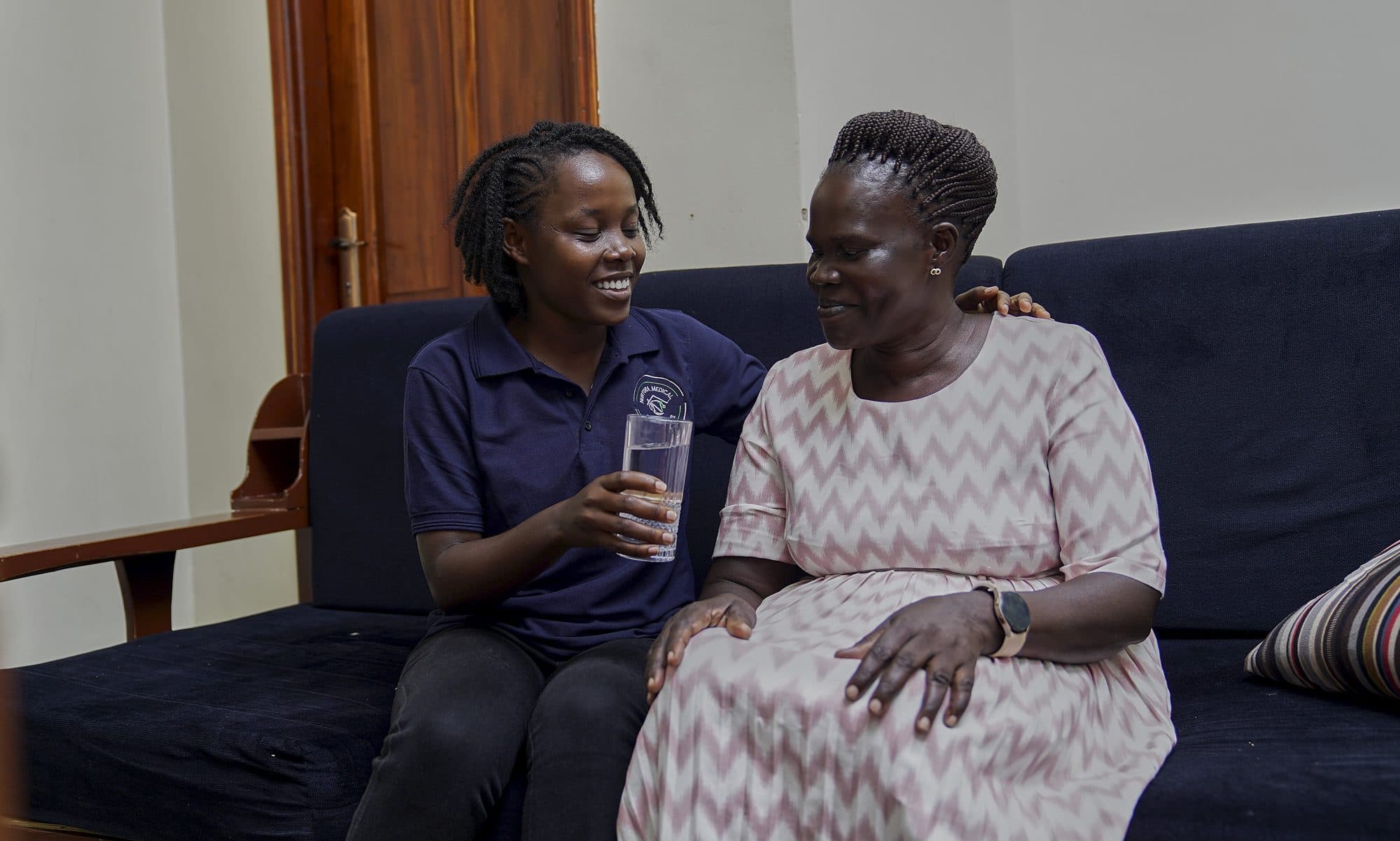 A Nurtura Care nurse comforting an elderly patient at home